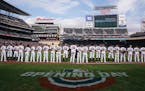 Minnesota Twins stand for the National Anthem Thursday, March 28, 2019 at Target Field in Minneapolis, Minn.