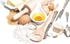 Baking ingredients eggs, flour, sugar, butter, yeast. Food background with antique cutlery, istock photo