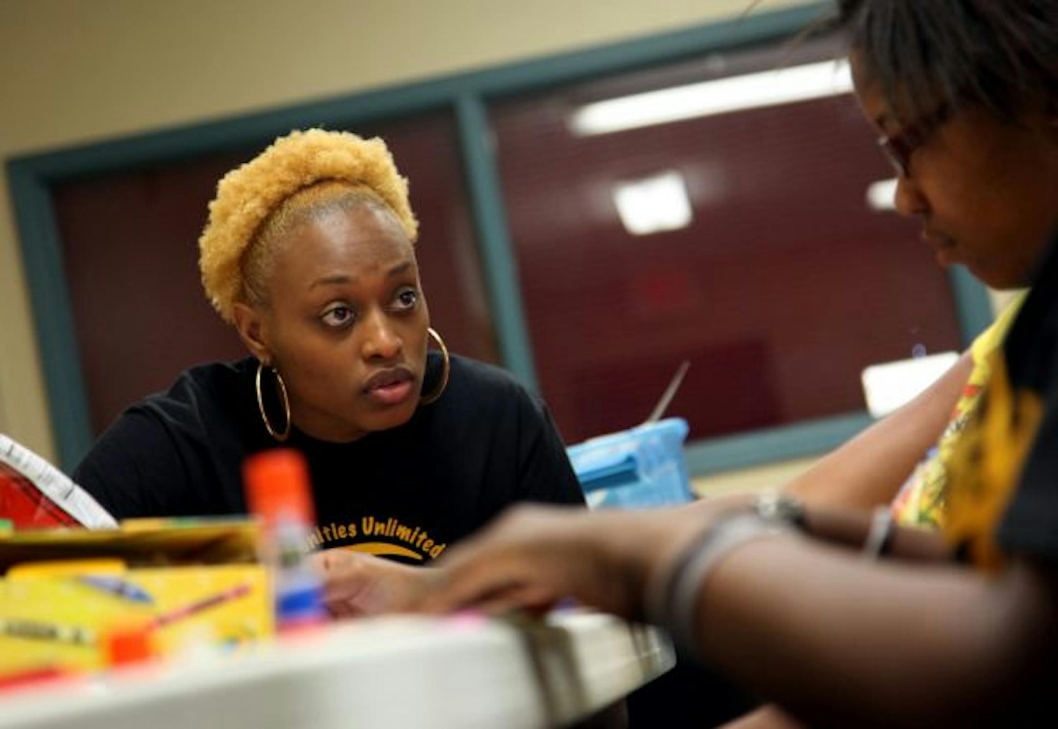 Lynx forward Charde Houston talked with a girl in her Y.O.U. program as she worked on a vision board that would serve as a reminder of her career goals.