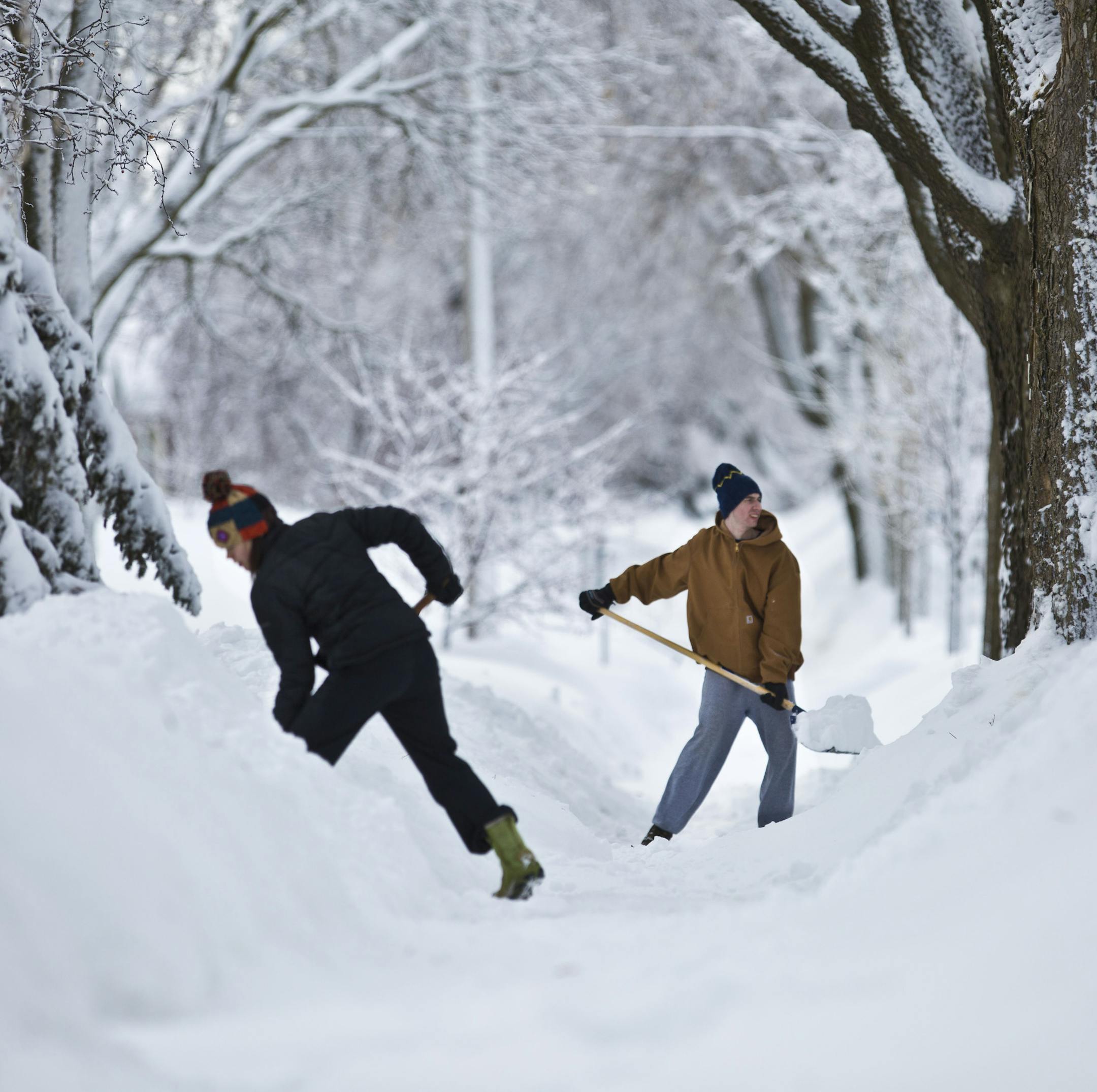 Neighbors Andrea Page and Peter Jorgensen were two of several neighbors clearing the sidewalk of their Minneapolis neighborhood which had still yet to be plowed the morning after 10.5 inches of snow fell in the Minneapolis, Minn., on Friday, February 22, 2014. ] (RENEE JONES SCHNEIDER reneejones@startribune.com) ORG XMIT: MIN1402211137444154