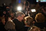 Republican gubernatorial candidate Scott Jensen stands with his wife, Mary, in front of supporters and members of the news media on Nov. 8 at the Minn
