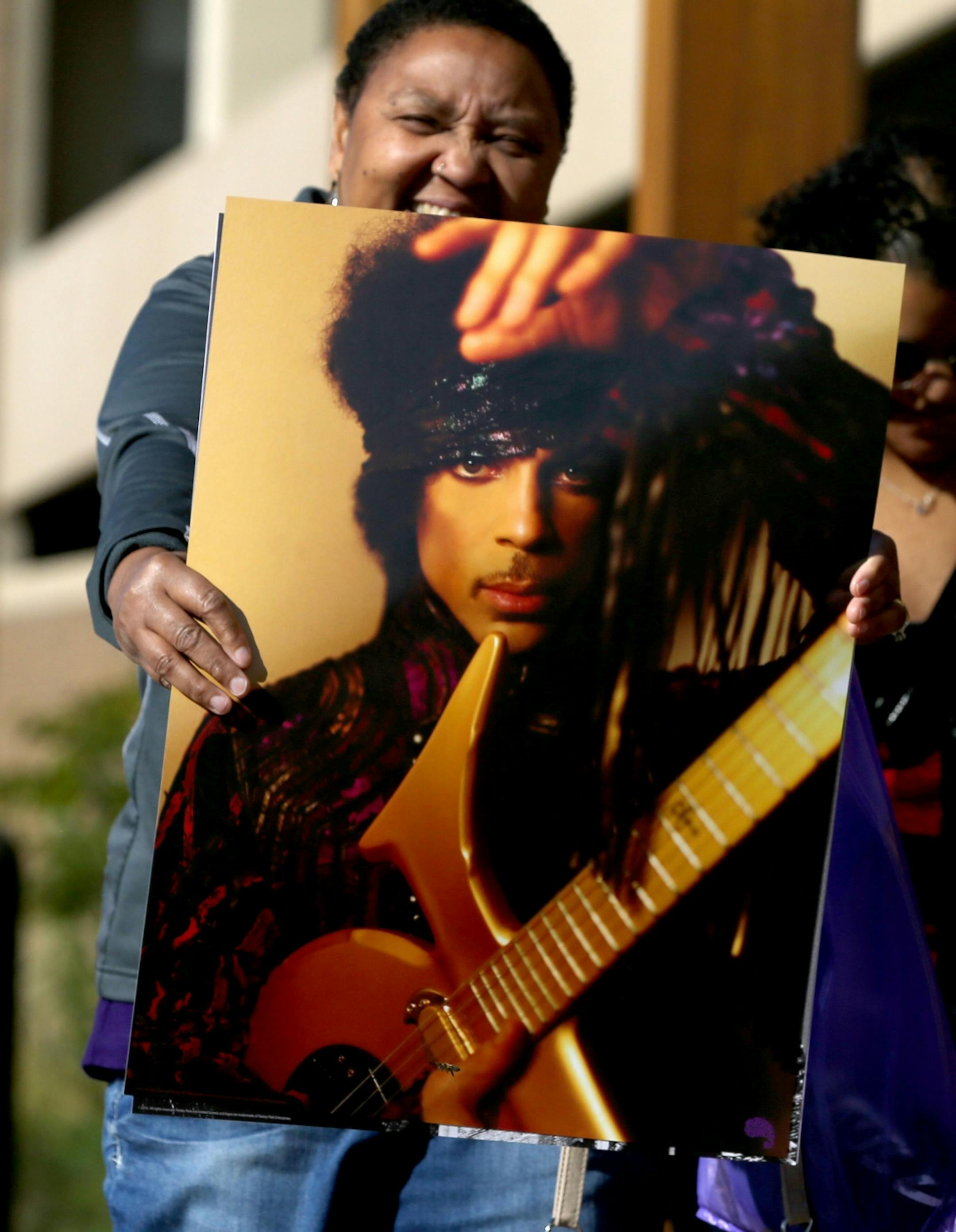 Gwen Ghess of Plymouth holds one of the Prince posters she bought during the first Paisley Park Tour Thursday, Oct. 6, 2016, in Chanhassen, MN. Guess did the tour with her daughter Deja and husband Tim, not pictured. "God gave us the gift of Prince," Tim said was evident after touring Paisley Park.