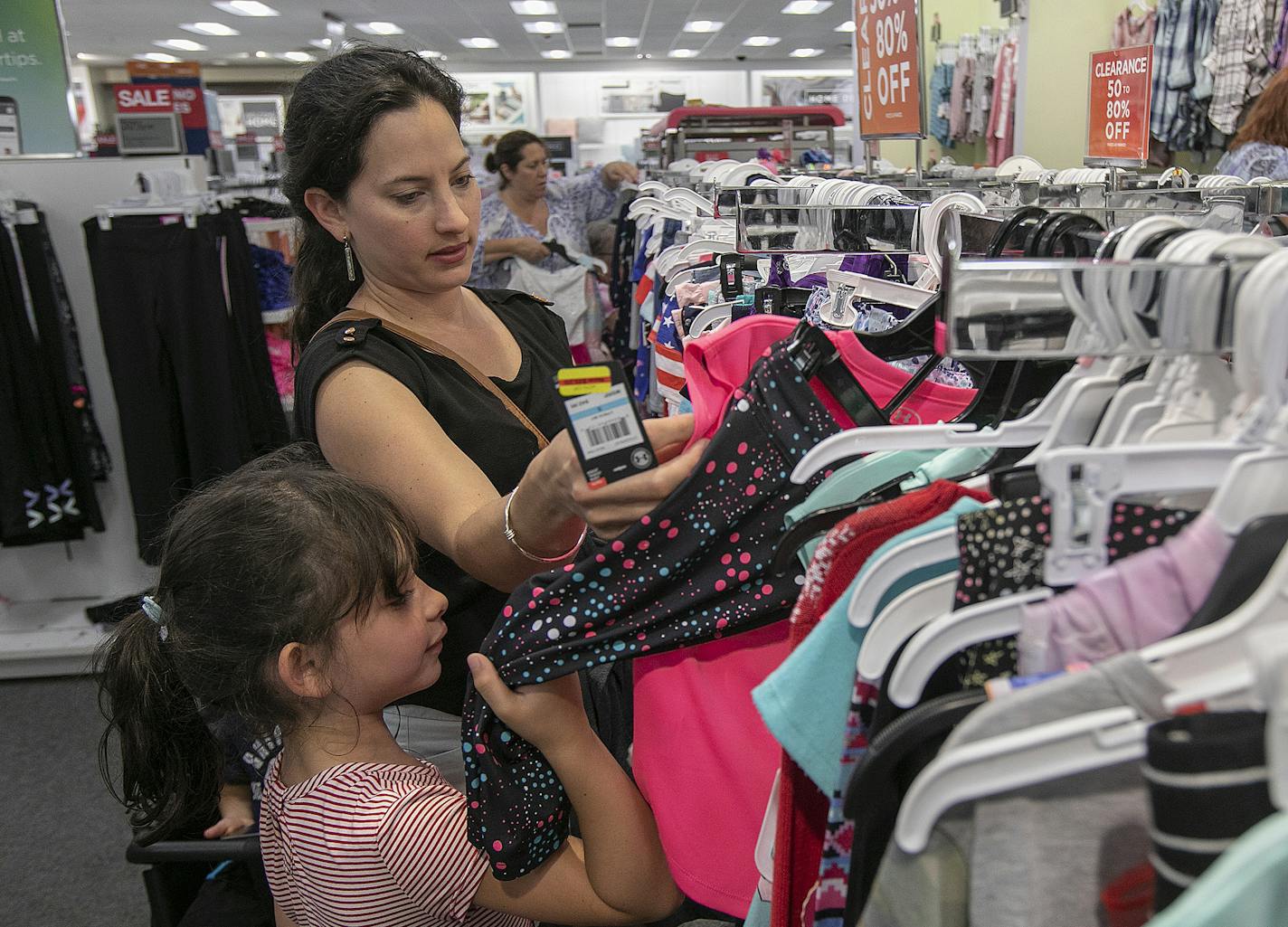 Paula Rosado, of Meriden, shops for clothes for daughter, Camila, 6, during tax-free week at Kohl's in Wallingford, Conn., Mon., Aug. 19, 2019. (Dave Zajac /Record-Journal via AP)