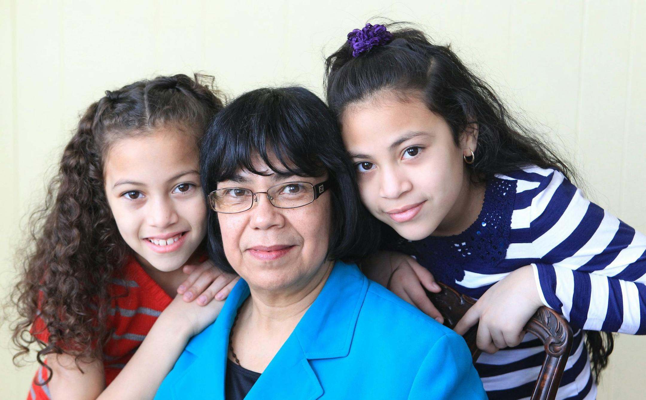 Maria Turcios, center, is shown with her granddaughters Brianna Munoz, 8, left, and Paola Munoz, 10, right, on March 9, 2014. Family members have five different immigration statuses. (Charles Fox/Philadelphia Inquirer/MCT)