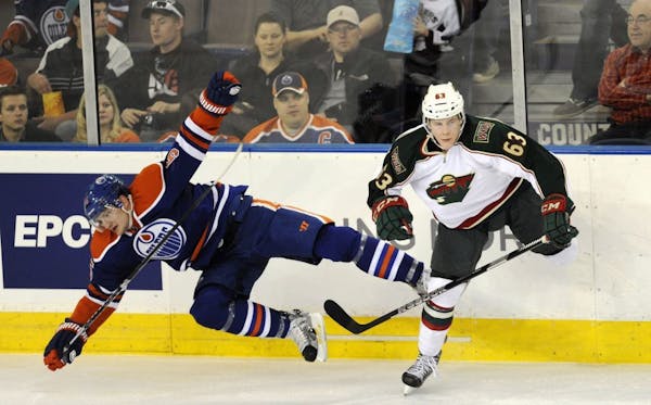 Charlie Coyle, right, checks the Edmonton Oilers' Ladislav Smid during second period