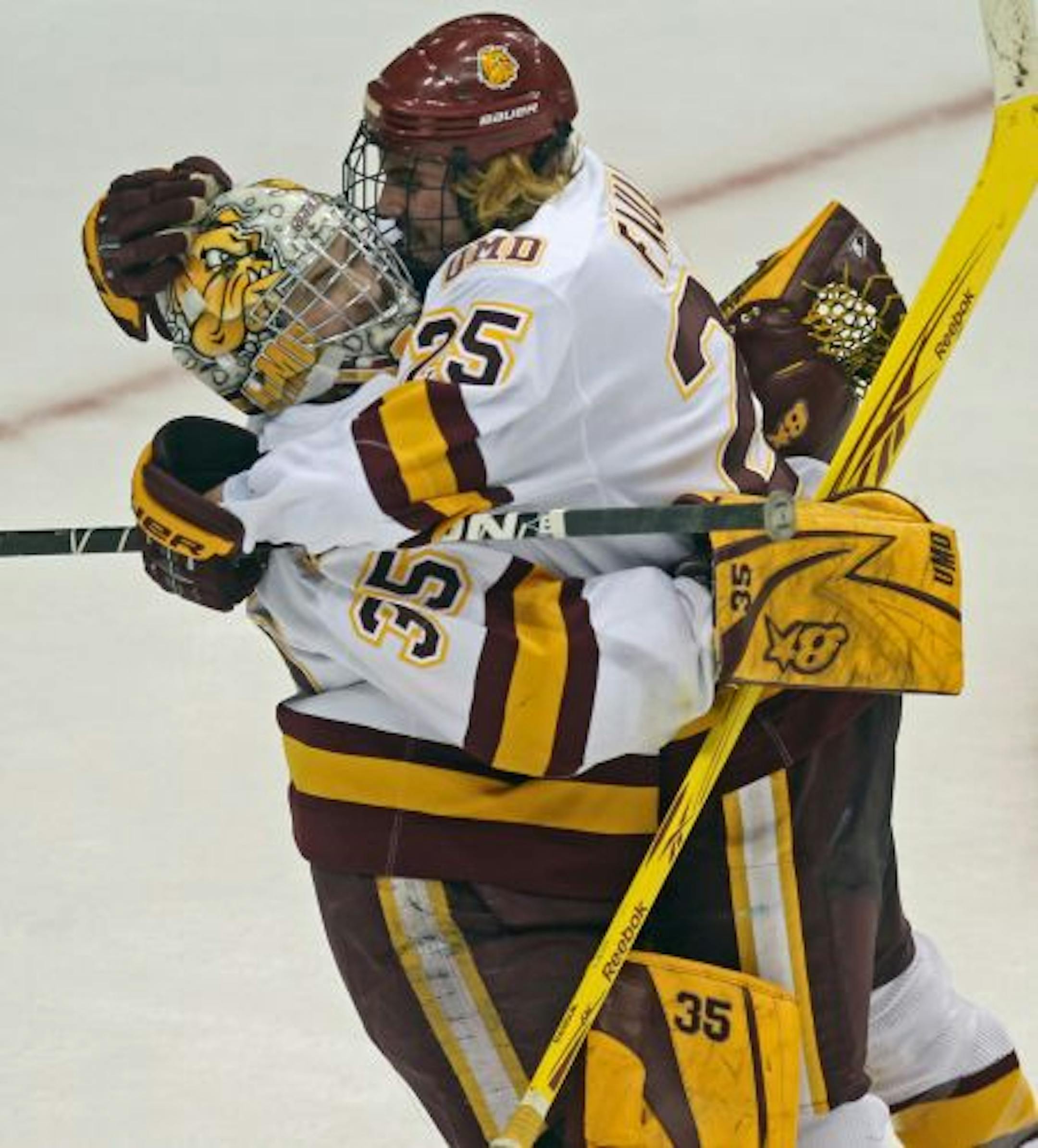 NCAA Frozen Four Semifinals, Minnesota Duluth vs Notre Dame. (left to right) Duluth goalieKenny Reiter and Justin Faulk celebrated their win over Notre Dame at the end of the game.