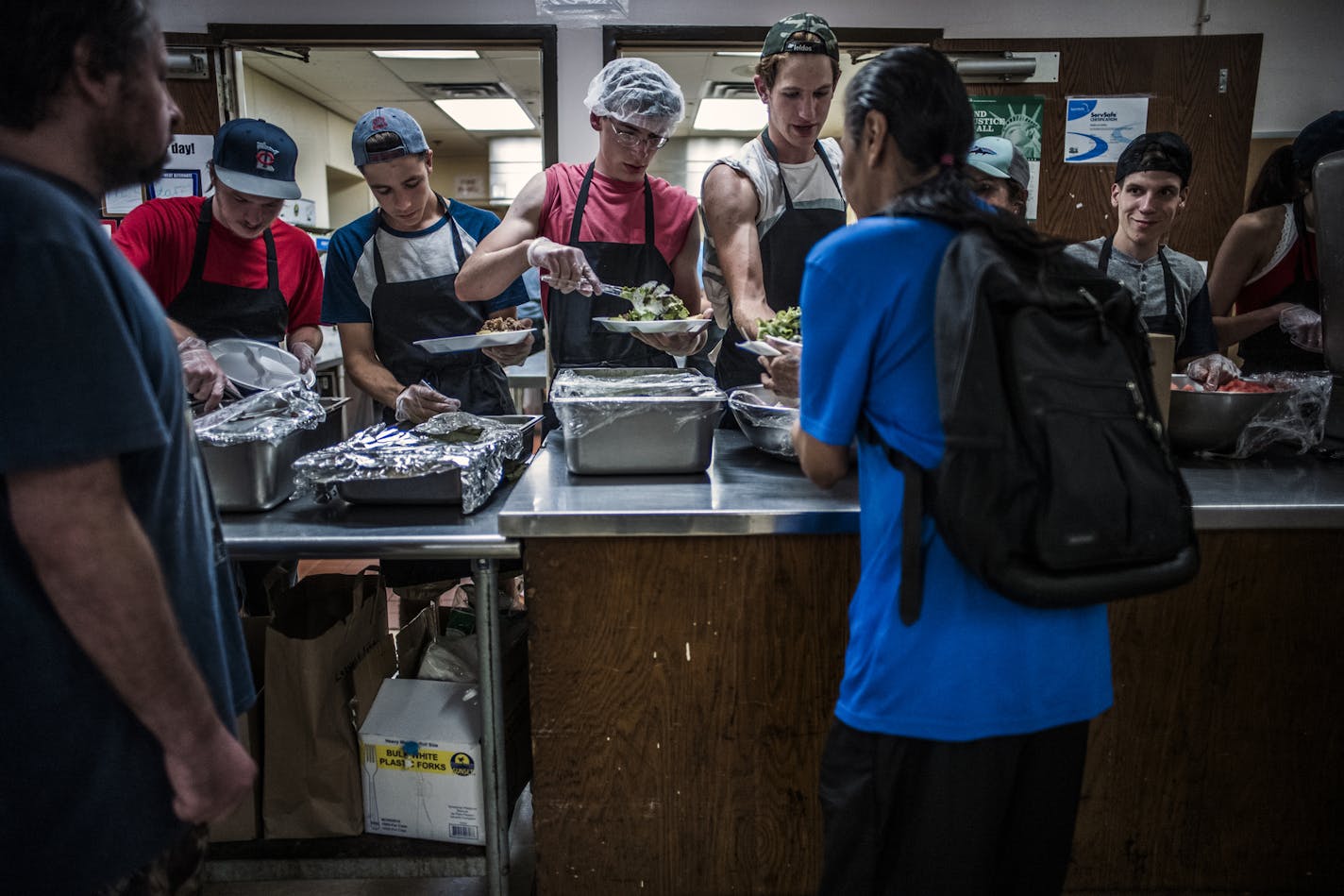 The dinner hour is busy at Loaves & Fishes in Minneapolis, which is on track to serve a record 1 million meals this year. On the menu, Philly steak on a bun with a green salad and zucchini from the kitchen's gardens.