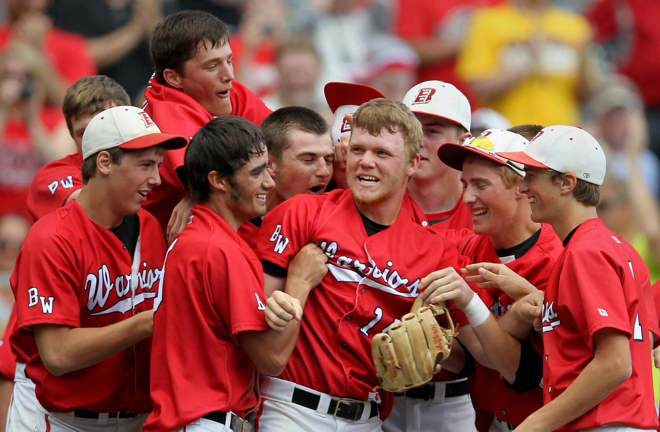 BOLD, Olivia's Logan Sandgren, center, celebrates with teammates following the Osakis vs. BOLD, Olivia Class A boys baseball high school championship at Target Field on Monday, June 17, 2013. BOLD ,Olivia won the championship game 3-0. ] (ANNA REED/STAR TRIBUNE) anna.reed@startribune.com (cq)