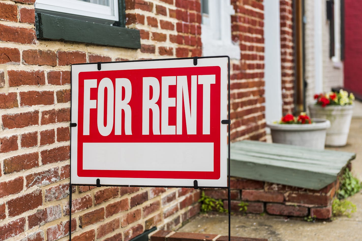 Red For Rent sign closeup against brick building. (Credit: Getty Images/iStockphoto) ORG XMIT: MIN1801191410370364