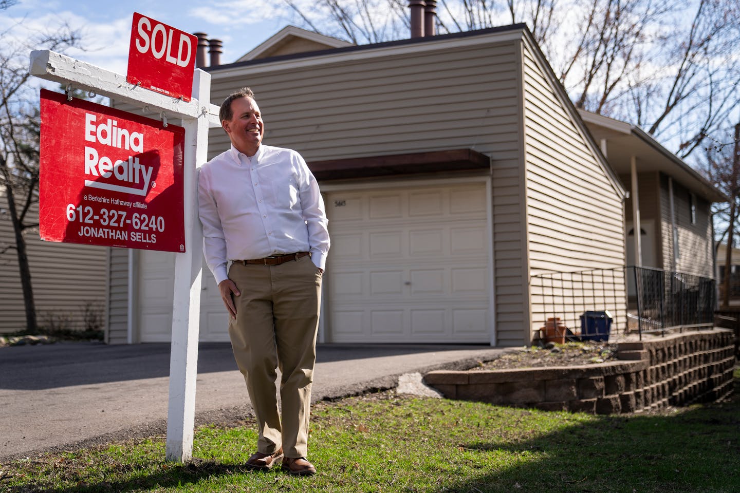 Realtor Jonathan Sells posed for a portrait next to a SOLD sign ouside a home he recently sold in Minneapolis on Monday.
