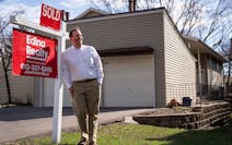 Realtor Jonathan Sells posed for a portrait next to a SOLD sign ouside a home he recently sold in Minneapolis on Monday.