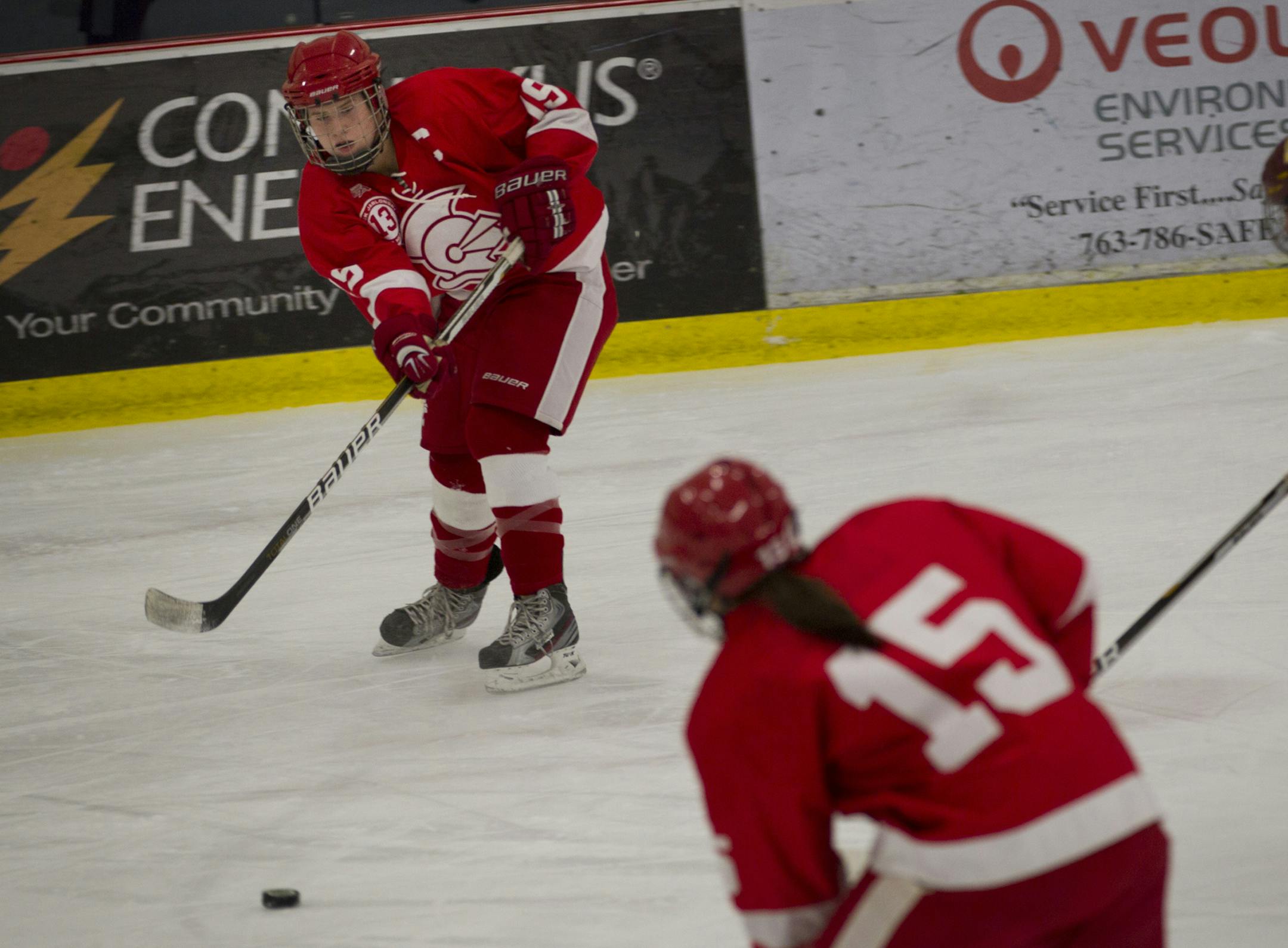 Benilde-St. Margaret Kelly Pannek passed the puck to teammate Jackie Pieper in the first period against Irondale at the National Sports Center in Blaine, Minn., on Tuesday, January 24, 2012. ] (RENEE JONES SCHNEIDER/ reneejones@startribune.com) Kelly Pannek #19, Jackie Pieper #15 ORG XMIT: MIN2012112710561725