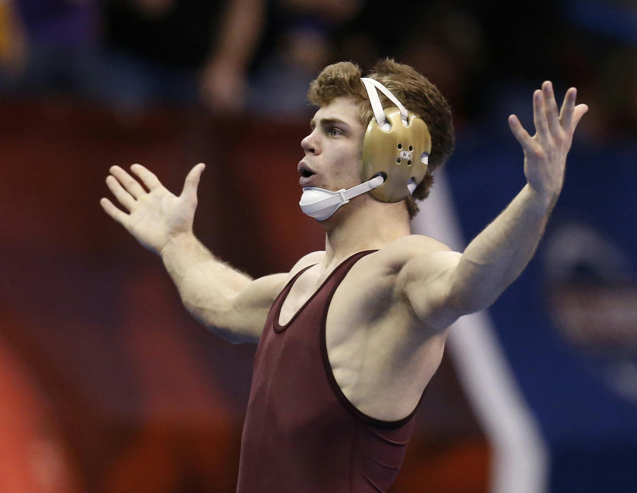 Minnesota's Dylan Ness gestures to the crowd after defeating Nebraska's James Green in a 157-pound match in the quarterfinals of the NCAA Division I wrestling championships in Oklahoma City, Friday, March 21, 2014. (AP Photo/Sue Ogrocki)