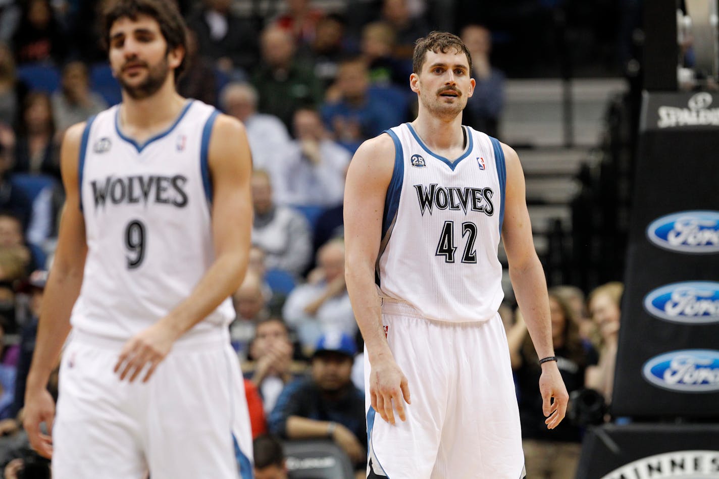 Minnesota Timberwolves forward Kevin Love (42) and guard Ricky Rubio (9), of Spain, stand on the court during the fourth quarter of an NBA basketball game against the Utah Jazz in Minneapolis, Wednesday, April 16, 2014. The Jazz won 136-130 in double overtime. (AP Photo/Ann Heisenfelt)