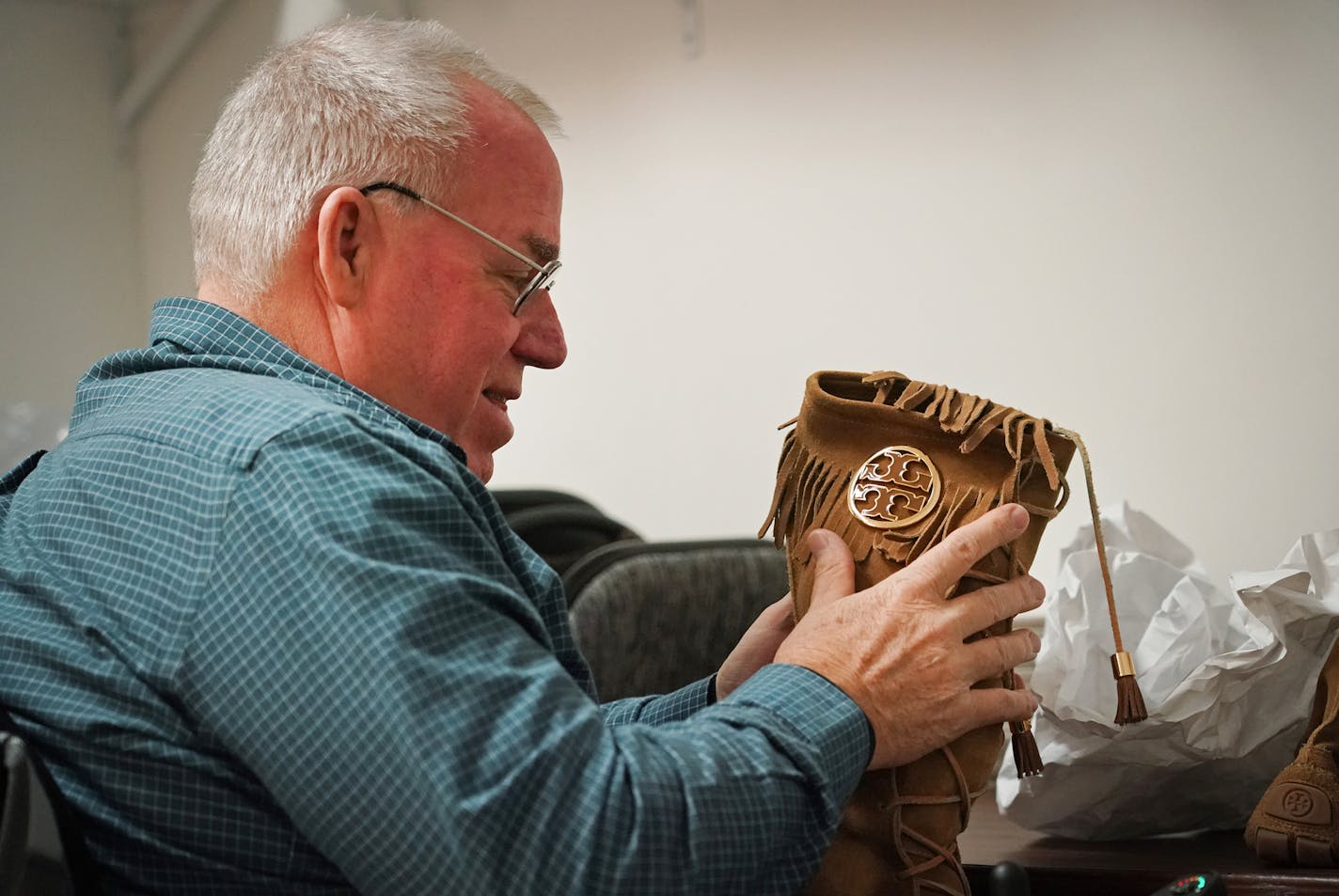 Employee John Kline worked diligently to stuff a pair of Tory Burch boots so they'd stand upright as they're displayed in the Gateways Thrift Shop in Hopkins. ] Shari L. Gross &#xa5; shari.gross@startribune.com Sha'arim, a Minnetonka-based nonprofit aiming to help those in the Jewish community with special needs, has opened Gateways Thrift Shop in Hopkins as a part of a new vocational pilot program. The first class of interns are wrapping up the training program, which is designed to teach job a