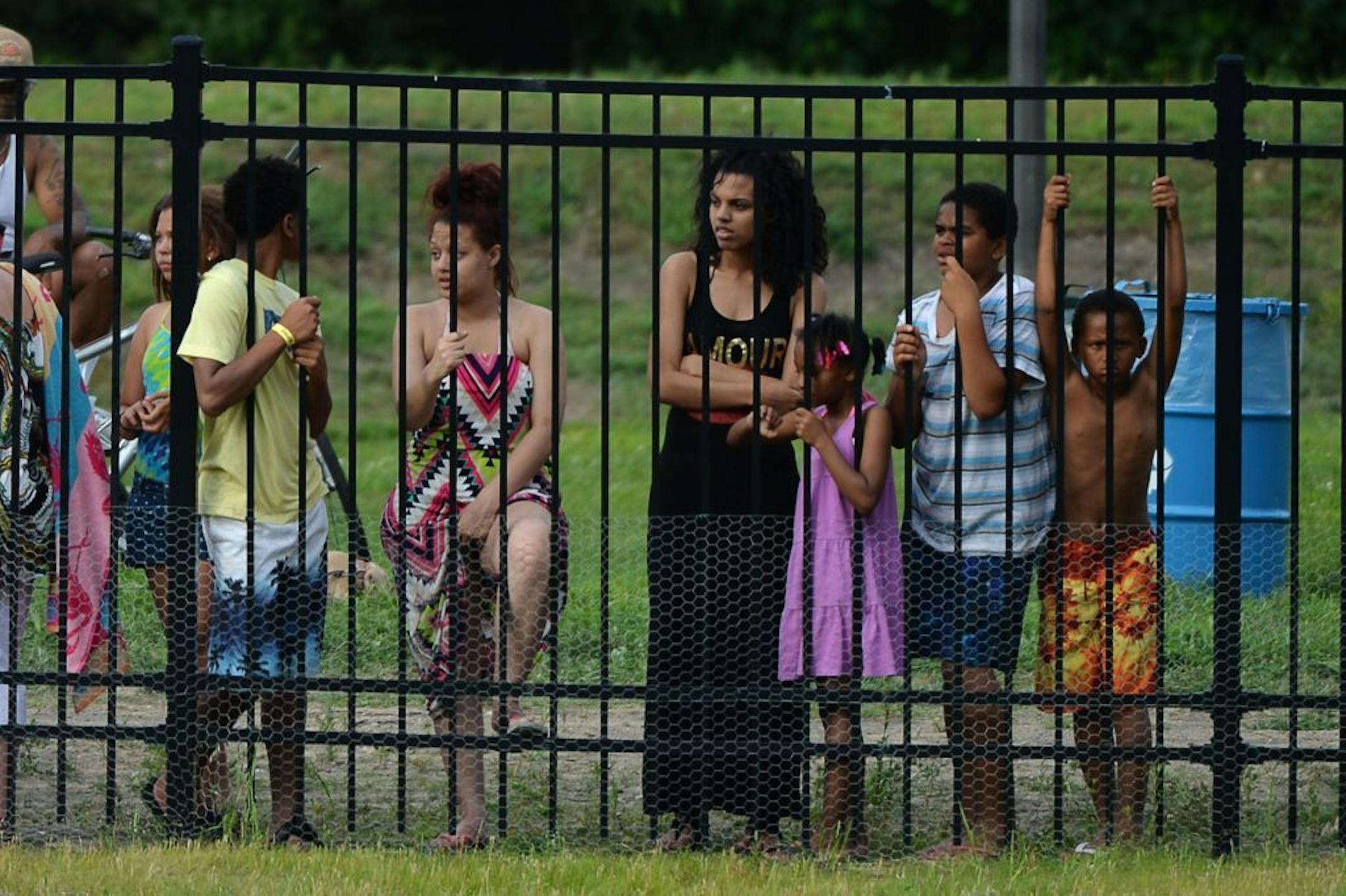 People watched as fire officials searched for a body in Webber Pool in Minneapolis Minn., on Saturday July 25, 2015. No body was found and the pool will resume normal hours on Sunday July 26, 2015.