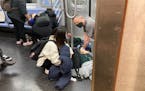 Wounded commuters are given first aid after a shooting on a New York subway train on Tuesday morning, April 12, 2022. Multiple people were shot on the