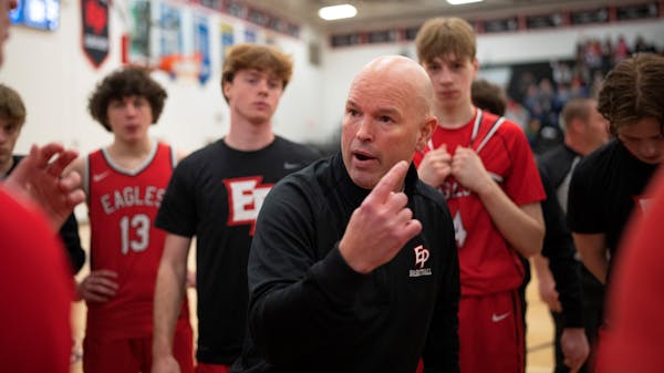 Eden Prairie boy's basketball coach David Flom talked to his team during a first half timeout as he coached his first game Tuesday night, January 24, 