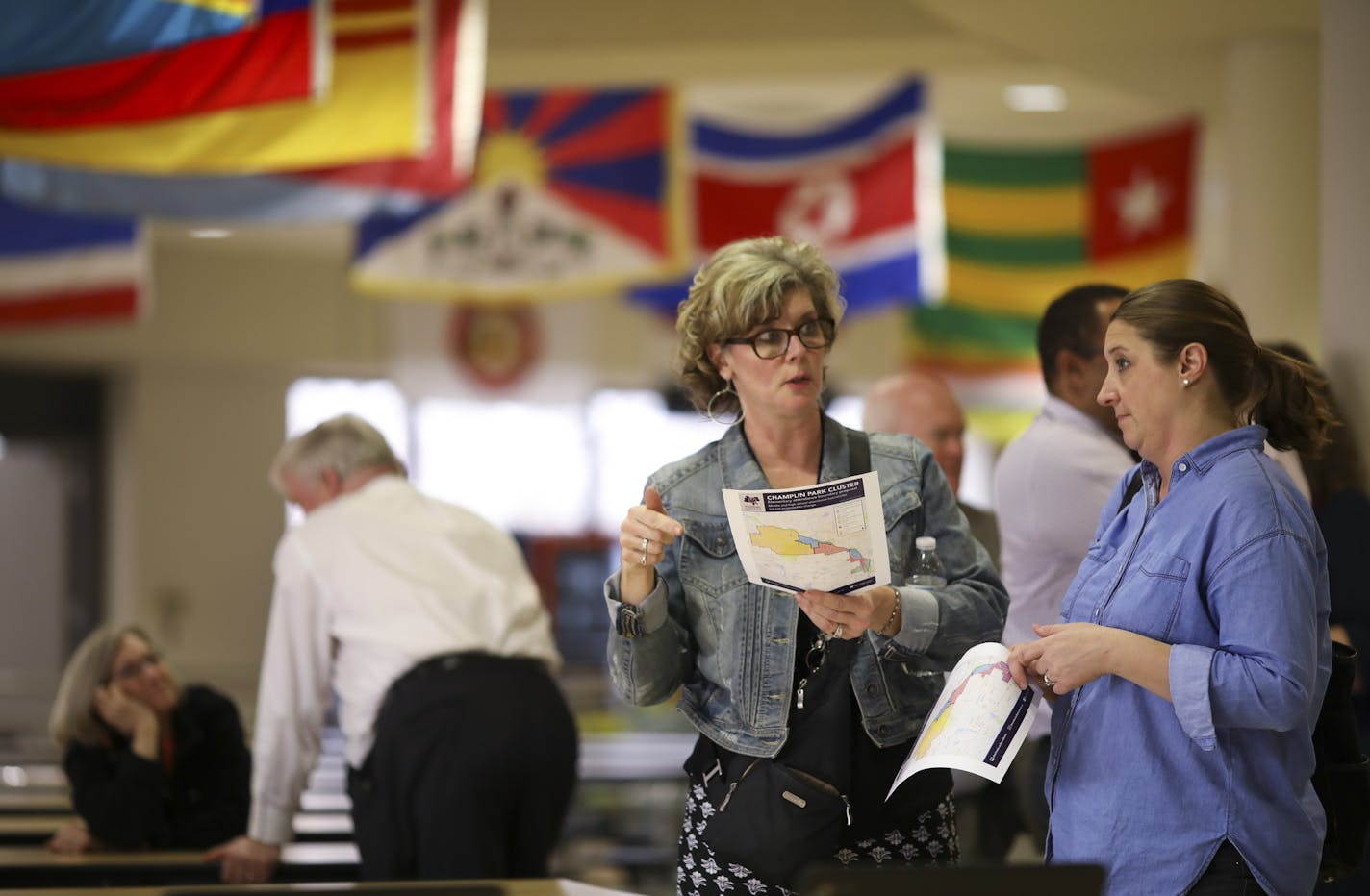 Kim Nelson, assistant principal at Champlin-Brooklyn Park Academy for Math and Environmental Science, left, looked at a map of the proposed boundary changes with Anita Carline, a parent of a student in the district, after the informational meeting Tuesday evening. ] JEFF WHEELER &#xef; jeff.wheeler@startribune.com Some parents are outraged over proposed new elementary school boundary changes in Anoka-Hennepin Schools. A community meeting about the changes was held Tuesday night, May 1, 2018 at C