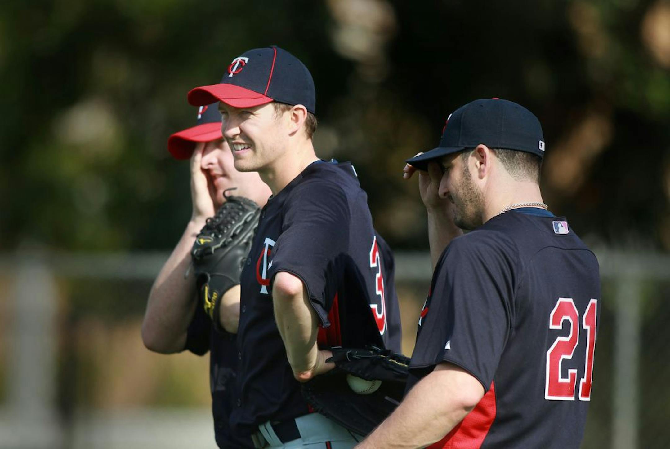 Minnesota Twins pitchers Matt Capps, left, Scott Baker, center, and Jason Marquis take to the mound for drills during the first day that pitchers and catchers reported for spring training at Hammond Stadium in Fort Myers, Florida, Sunday, February 19, 2012.