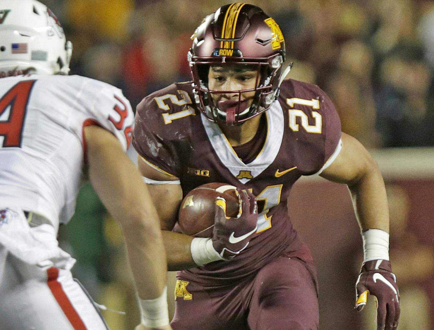 Minnesota running back Bryce Williams (21) runs against Fresno State linebacker George Helmuth (34) in the fourth quarter of an NCAA college football game, Saturday, Sept. 8, 2018 in Minneapolis. Minnesota defeated Fresno State 21-14. (AP Photo/Andy Clayton-King) ORG XMIT: MIN2018091118283060