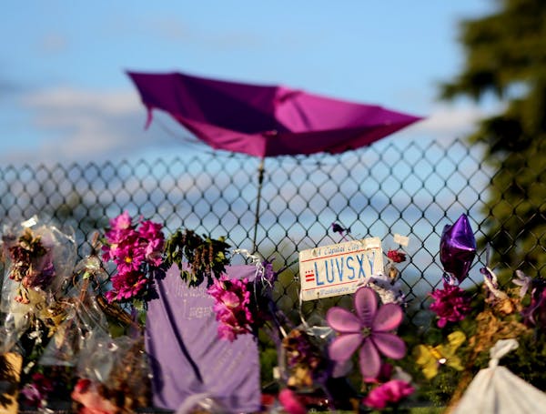 An umbrella and D.C. license plate left behind as a memento by Prince fans outside Paisley Park Sunday May 15, 2016, in Chanhassen, MN.