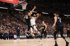 Rudy Gobert of the Timberwolves was guarded by an airborne Aaron Gordon of the Nuggets on Tuesday night at Ball Arena in Denver.