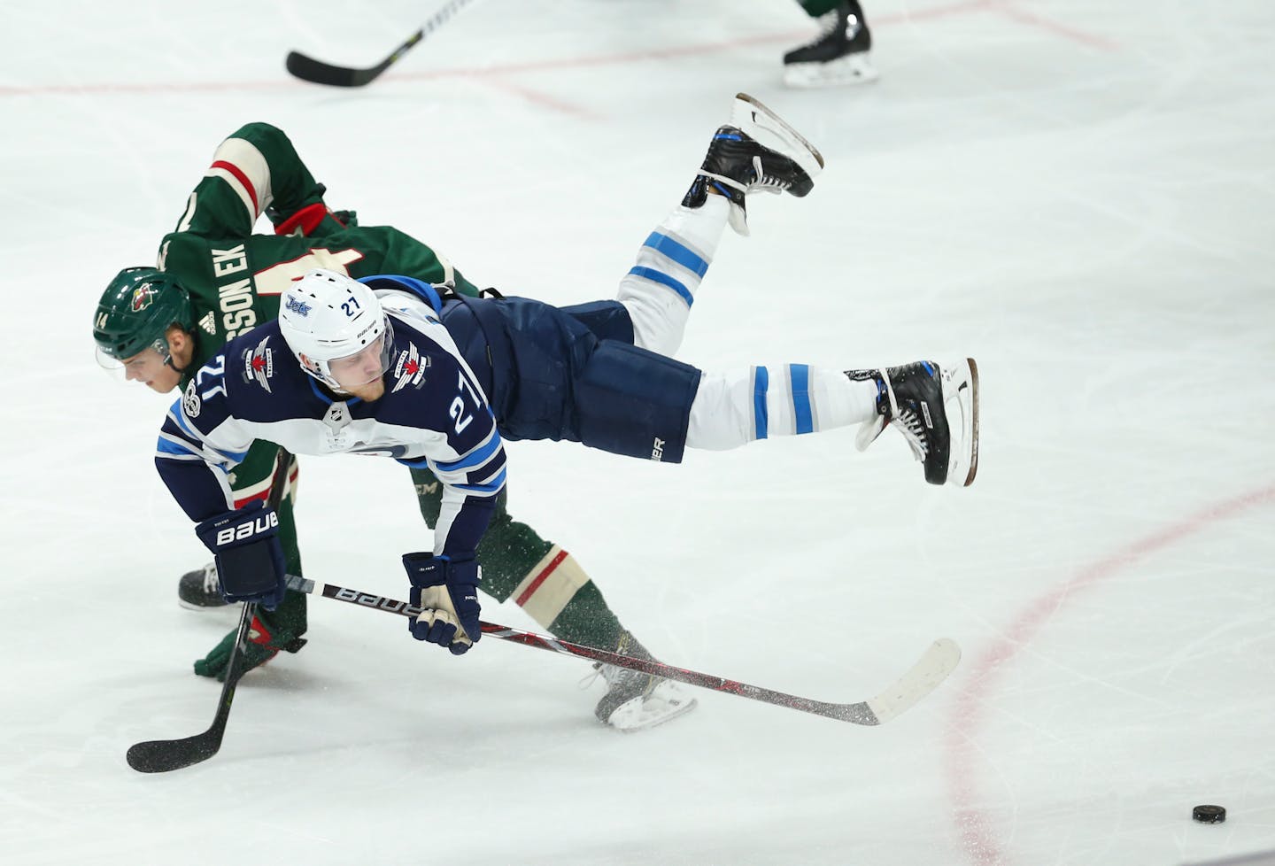 The Wild's Joel Eriksson Ek is upended by the Jets' Nikolaj Ehlers in October