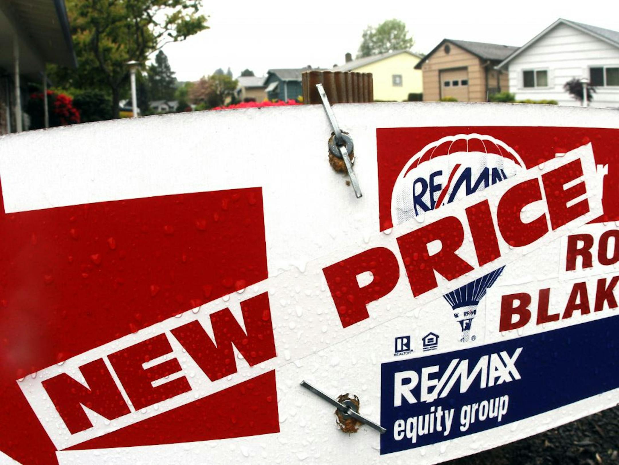 A home sale sign indicating a new price is seen here in King City, Ore., Tuesday, May, 31, 2011. U.S. single-family homes prices dropped into double-dip territory in March as the housing market remained bogged down by inventory and weak demand according to the S&P/Case Schiller composite index. Latest data shows home prices have reached their lowest prices since the housing bubble burst in 2006.