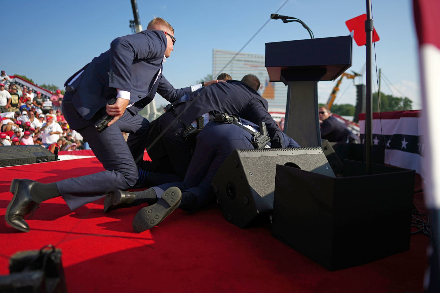 Secret Service agents cover former President Donald Trump after shots were fired in an assassination attempt at a campaign rally in Butler, Pa., on Ju