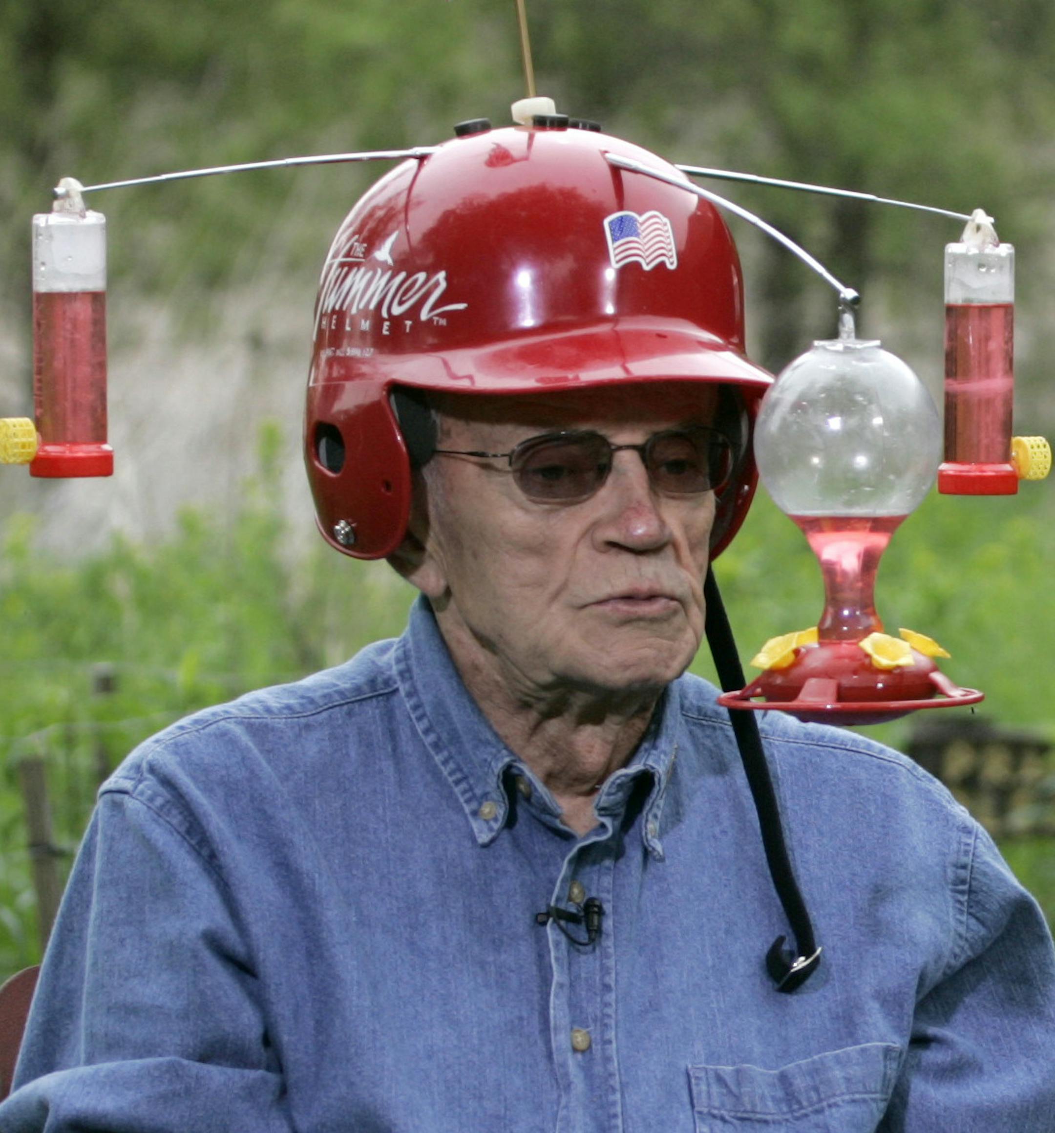 Dave Leslie wearing his Hummer Helmet during the Letterman show taping Tuesday afternoon. The raccoon at rear made a brief appearance to eat some bird seed that had fallen on the ground below a feeder at the nature center. Leslie was on camera for an extended period at the beginning of the show, regaling Letterman with hummingbird lore. Letterman checked in with Leslie throughout the show. Leslie said of his invention, "It really gives you an opportunity to study them. I've learned a whole lot."