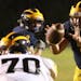Rosemount quarterback Cody Hogan (7) takes the snap from center before heading into the end zone on a quarterback keeper against Burnsville during the