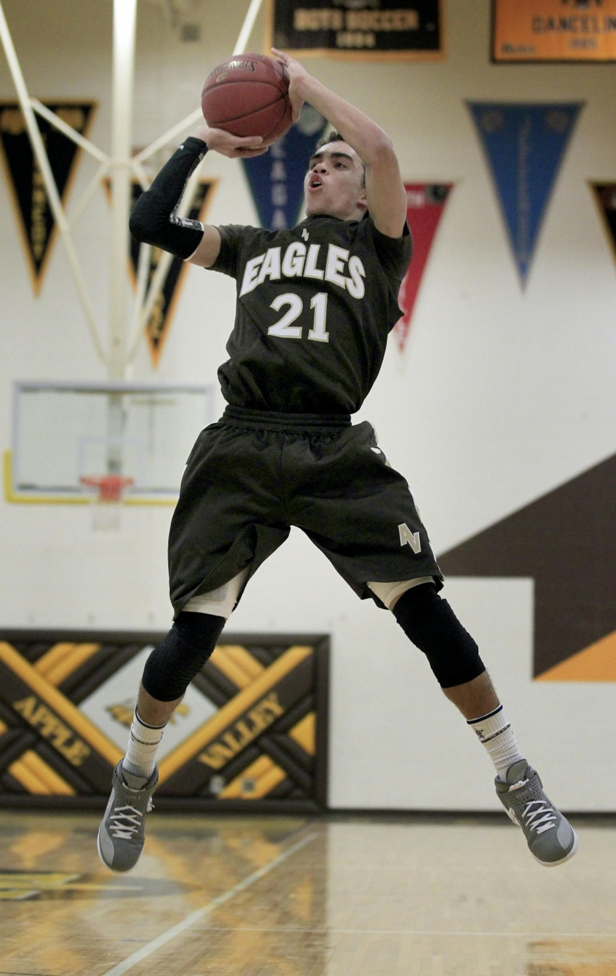 Apple Valley guard Tyus Jones (21) attempted and made a shot after being fouled in the first half.