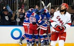Rangers defenseman Ryan Lindgren, left wing Jimmy Vesey and others celebrate following center Mika Zibanejad's goal against the Hurricanes during the 