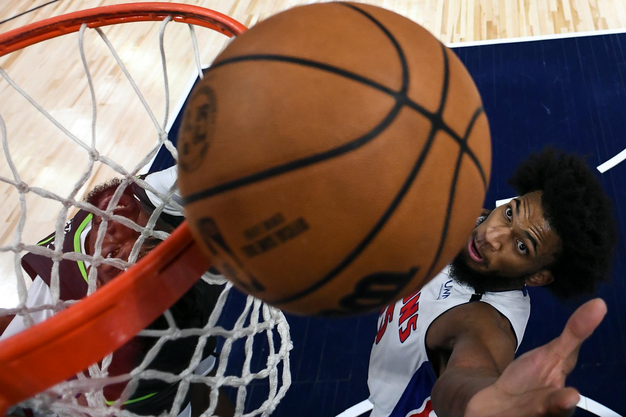 Detroit Pistons forward Marvin Bagley III (35) and Minnesota Timberwolves center Naz Reid (11) battle for a rebound during the first half.