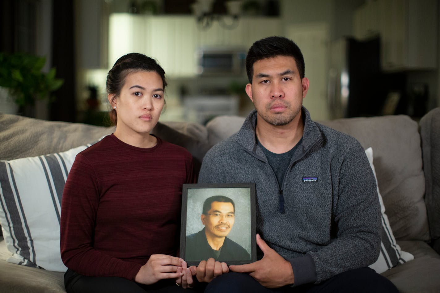 Siblings Sherry and Kevin Khottavongsa held a photograph of their father, Sinthanouxay Khottavongsa, who died after Brooklyn Center police tased him in 2015.