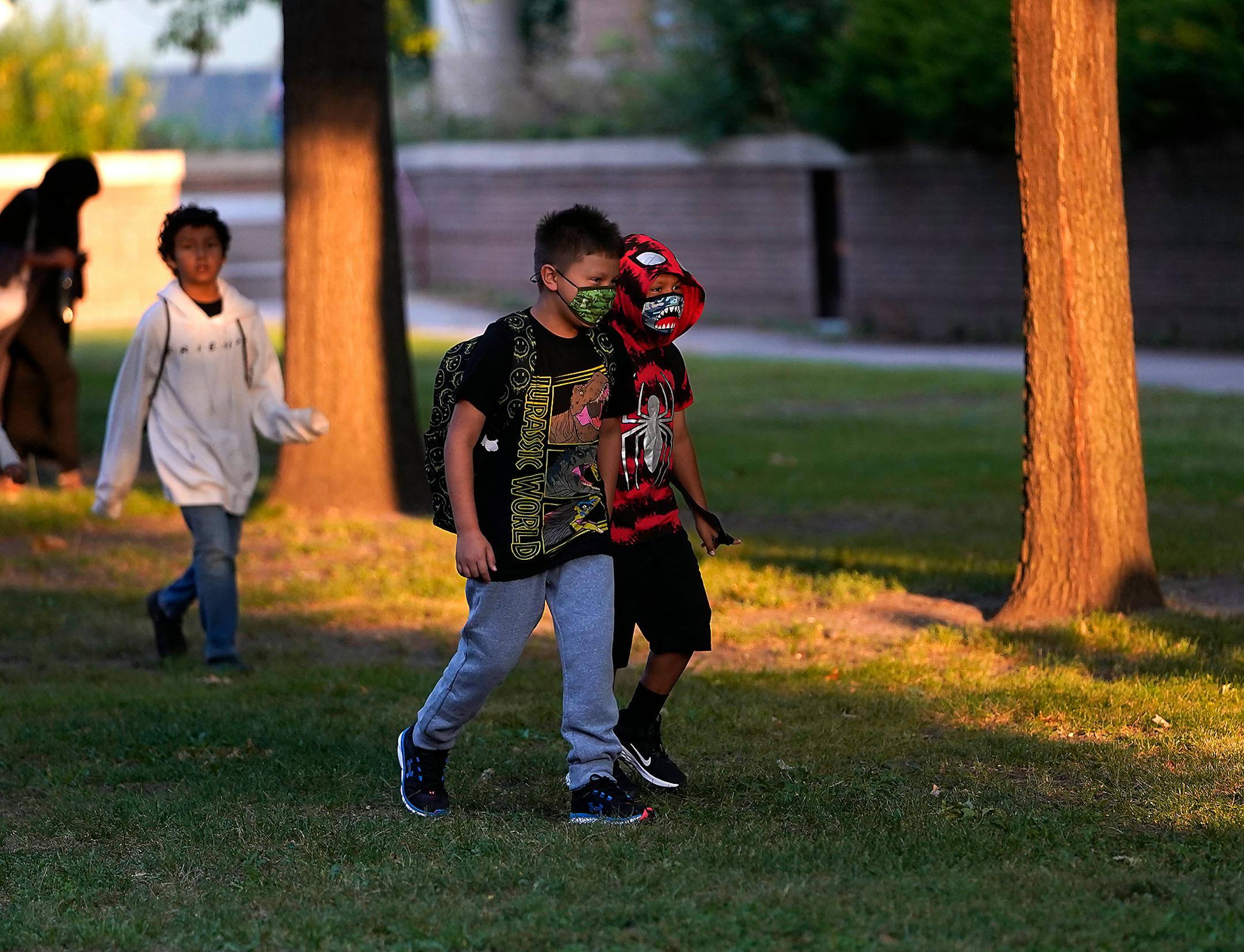 Though no longer required for attending, some students showed up in masks in the face of continuing COVID cases nationwide outside Anishinabe Academy and Sullivan STEAM School on the first day of school in Minneapolis.