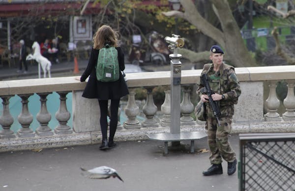 A French soldier patrols at the Sacre Coeur basilica in Paris, France, Wednesday, Nov. 18, 2015. A woman wearing an explosive suicide vest blew hersel