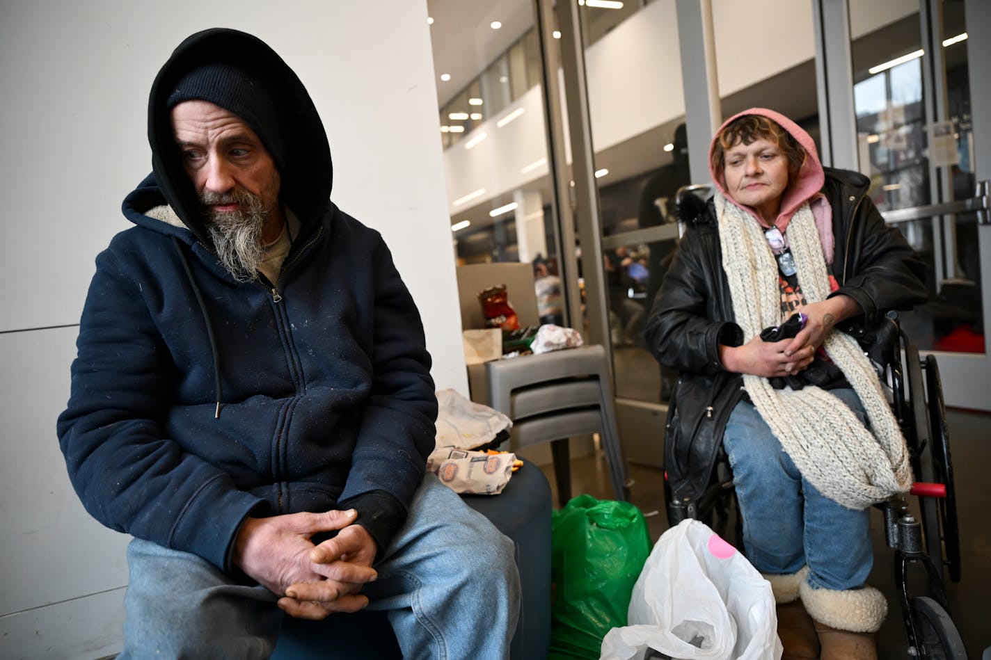 William Johnson and Laurie Mertz shelter from the cold Friday, Jan. 12, 2024 at the Dorothy Day Opportunity Center in St. Paul, Minn. "You get desperate in the cold," said Mertz. "It's kind of scary, especially at night. It seems like the colder it gets, the more people try to rob you."