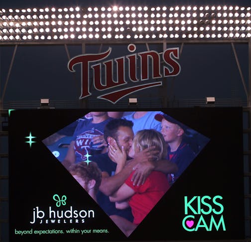 A couple kisses on the kiss cam during the Cleveland Indians vs. Twins baseball game at Target Field in Minneapolis, Minn., on Friday, July 19, 2013. ] (ANNA REED/STAR TRIBUNE) anna.reed@startribune.com (cq)