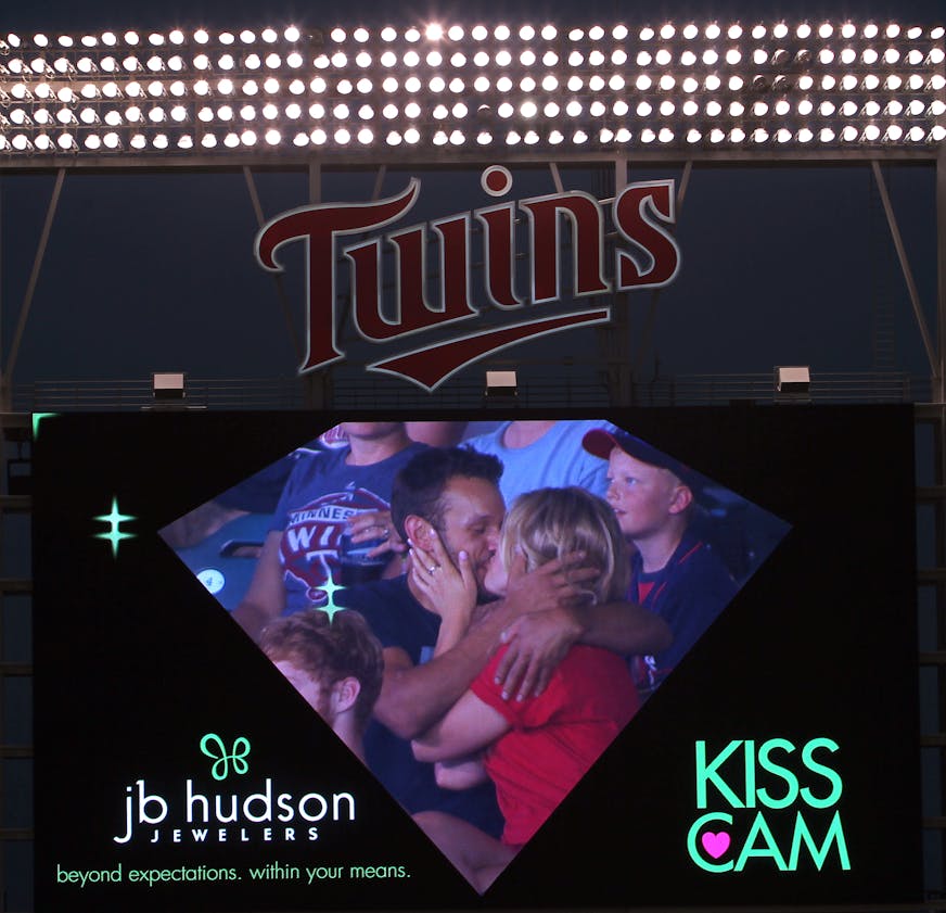A couple kisses on the kiss cam during the Cleveland Indians vs. Twins baseball game at Target Field in Minneapolis, Minn., on Friday, July 19, 2013. ] (ANNA REED/STAR TRIBUNE) anna.reed@startribune.com (cq)