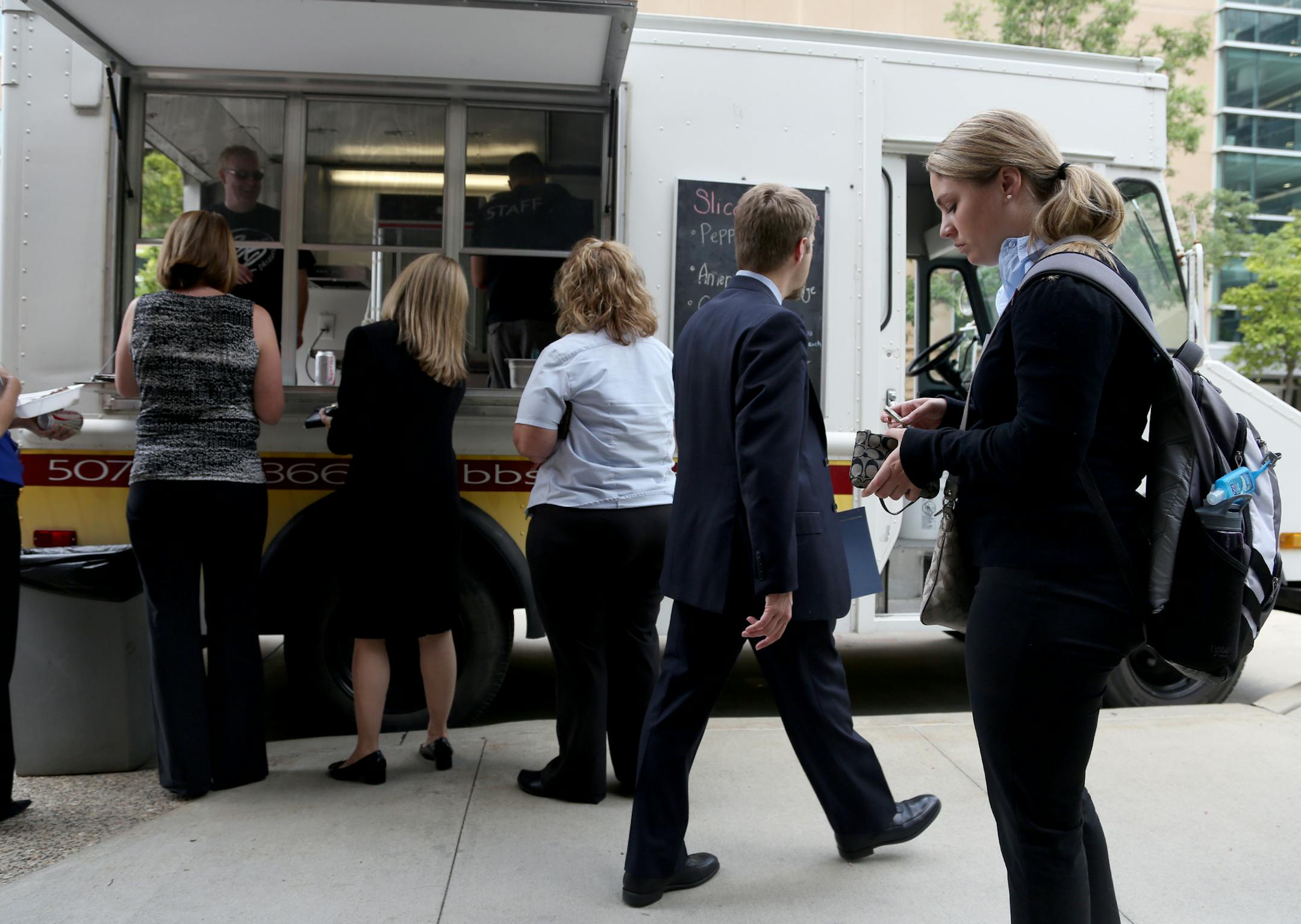 Customers lined up at the BB's Pizzaria food truck last summer in Rochester. City officials later shut the operation down, deeming it on public property.