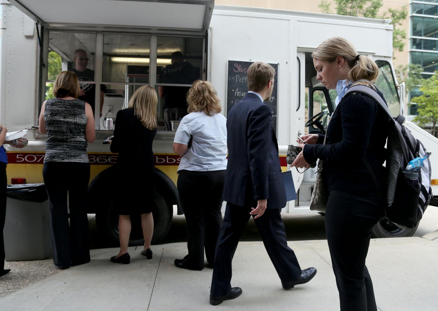 Customers lined up at the BB's Pizzaria food truck last summer in Rochester. City officials later shut the operation down, deeming it on public property.