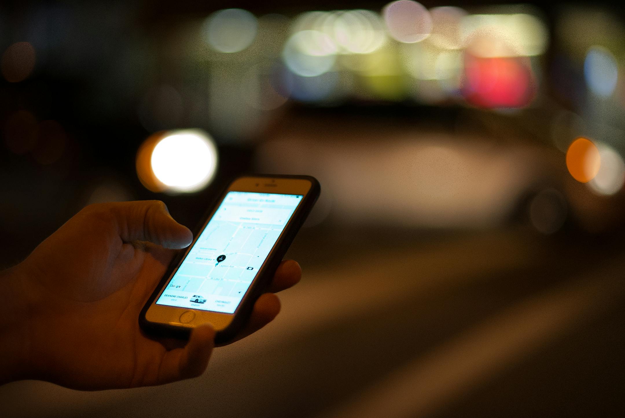 An Uber customer checked the status of his ride on his phone while waiting at the intersection of Lagoon Avenue and Hennepin Avenue late Saturday night. ] (AARON LAVINSKY/STAR TRIBUNE) aaron.lavinsky@startribune.com Uber and Lyft drivers picked up bar patrons at Lagoon Avenue and Hennepin Avenue in Minneapolis on Saturday, August 6, 2016. ORG XMIT: MIN1608142326251014