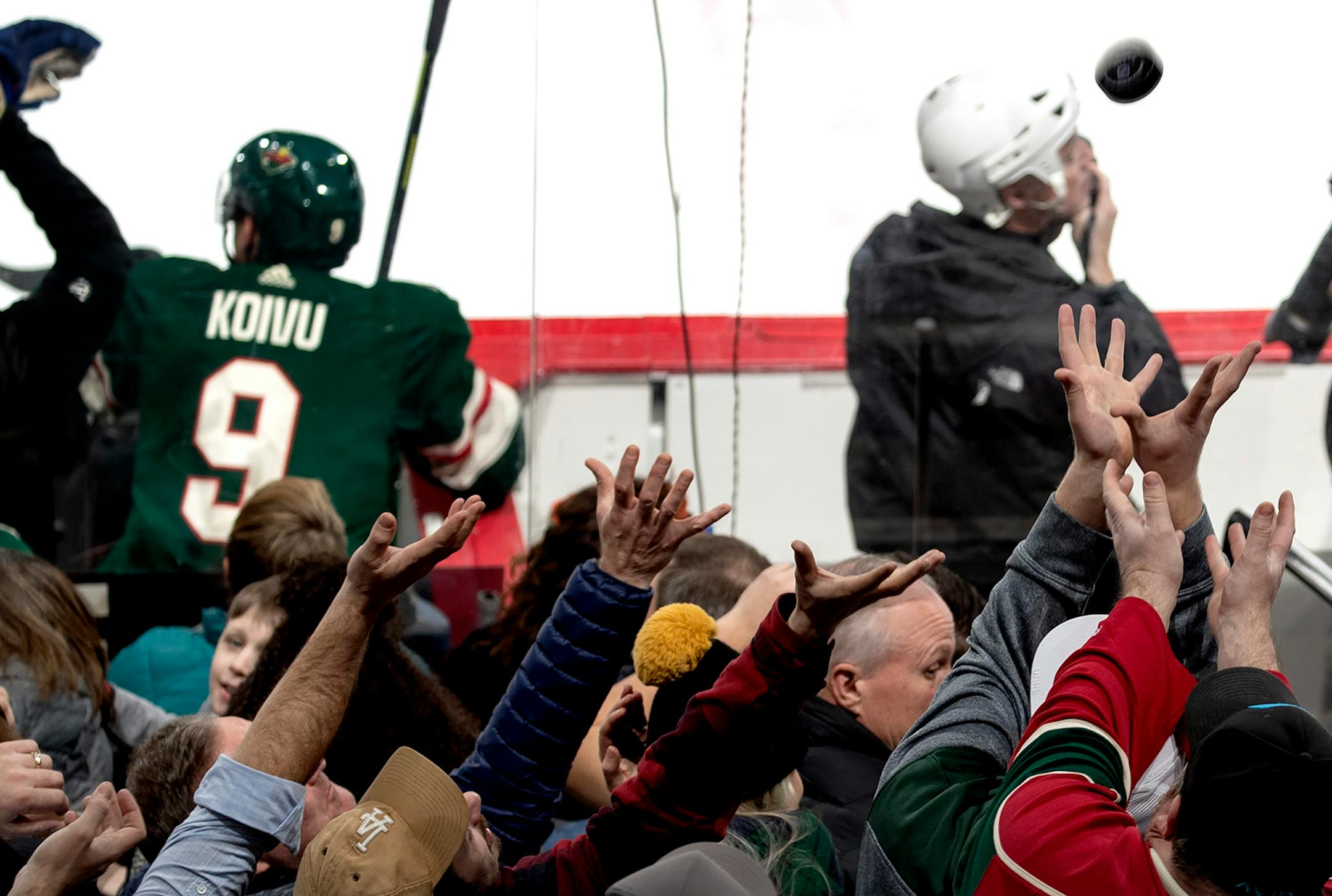 Fans reached out for a puck the flew into the stand in the third period.