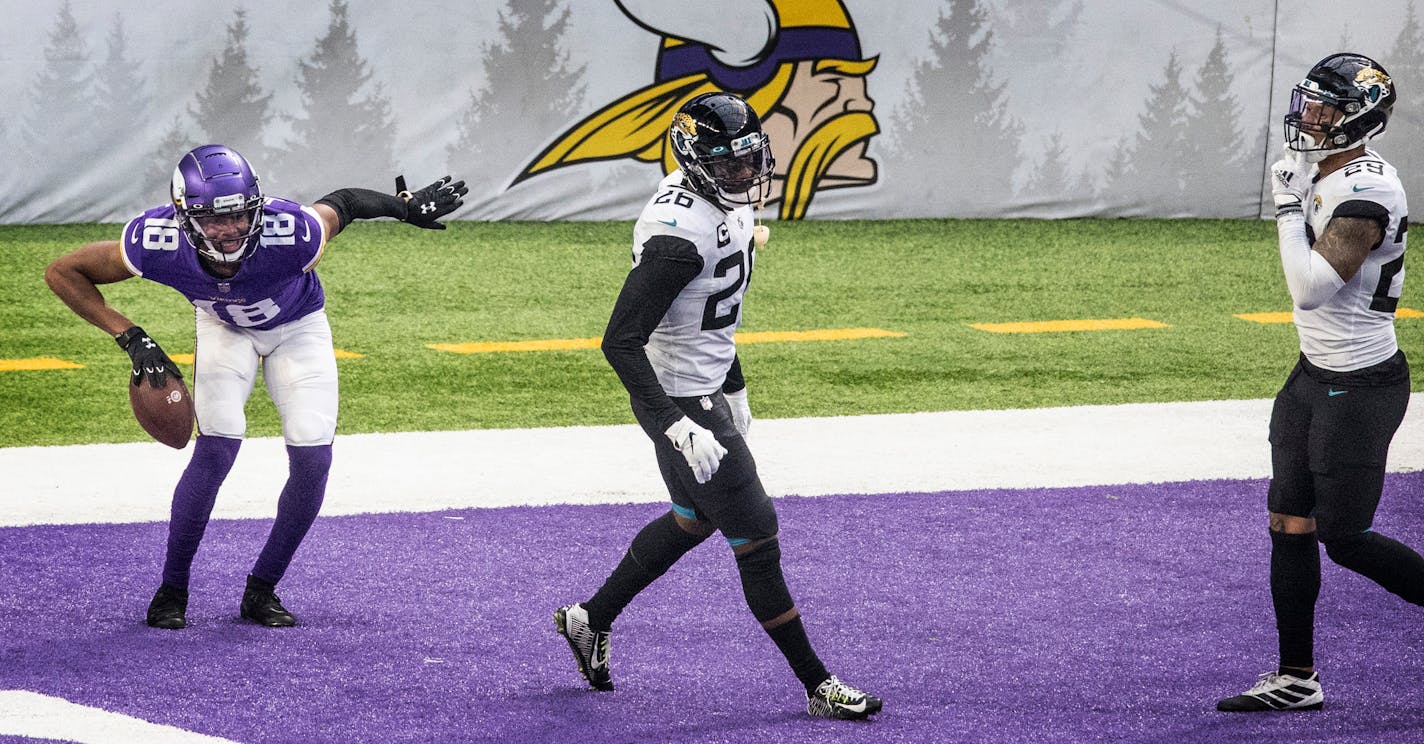 Vikings wide receiver Justin Jefferson celebrated his 20-yard touchdown catch in the third quarter as Jaguars free safety Jarrod Wilson, center, and Josh Jones walked of the field. But there wasn't much to celebrate, even though the Vikings slipped past the Jaguars 27-24 in overtime.