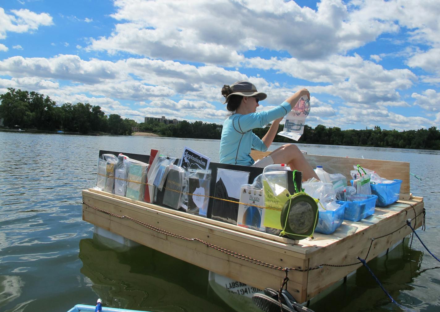 Sarah Peters on the floating library on Cedar Lake in August 2013. Photo courtesy of the Floating Library