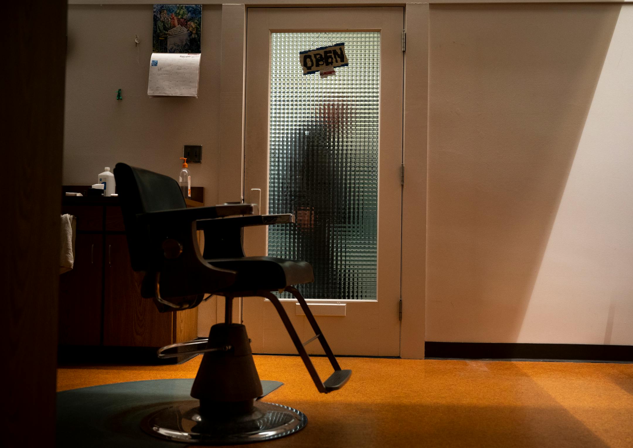 Bob Haddow, veteran barber and philosopher at the Grain Exchange Barbershop, shuts the door of his shop after turning off the lights and locking up for the night Wednesday. Haddo is out on Friday, thanks to remodeling of the 120-year-old building lobby by the Grain Exchange owner.