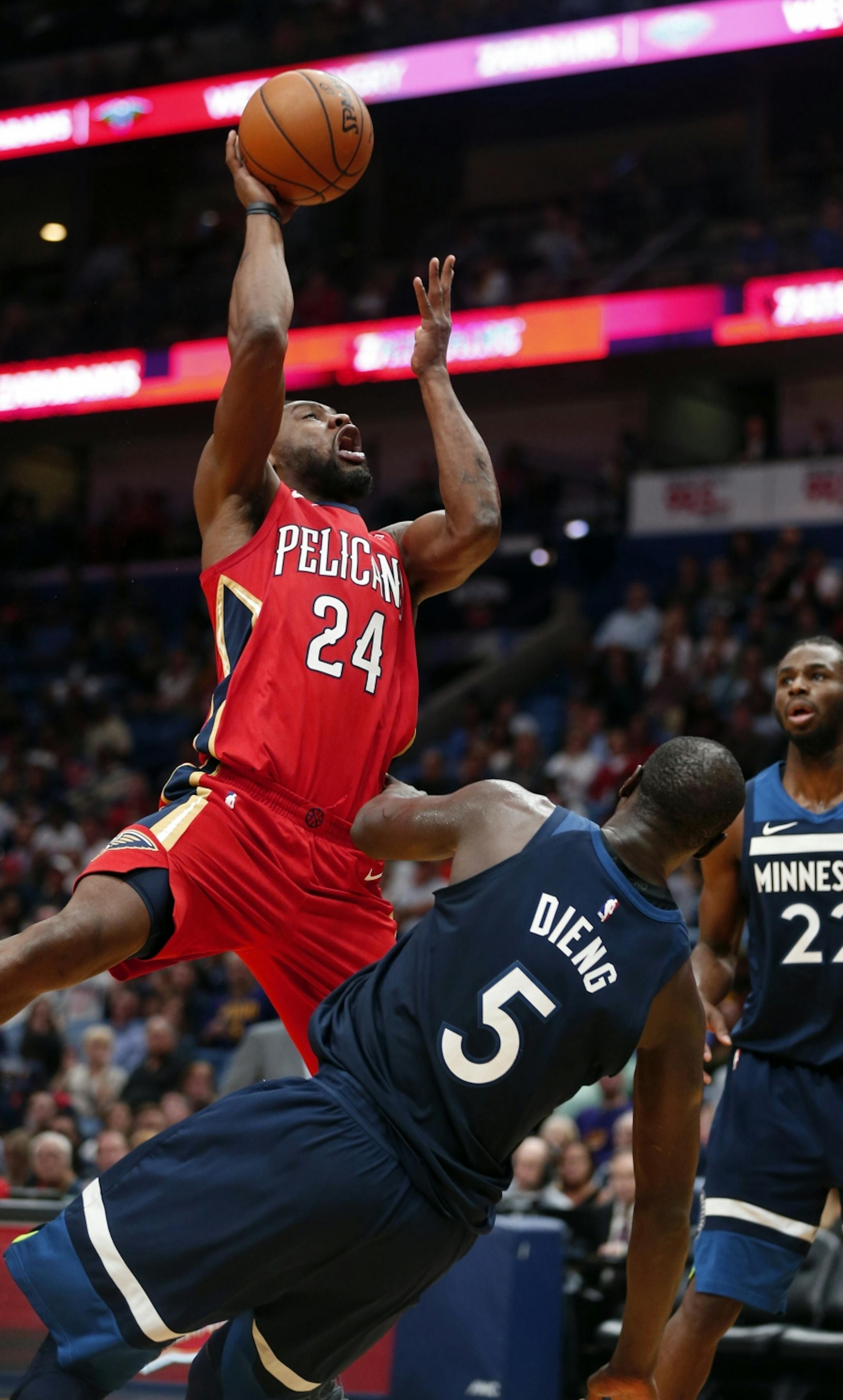 New Orleans Pelicans guard Tony Allen (24) commits an offensive foul as he drives to the basket against Minnesota Timberwolves center Gorgui Dieng (5) during the second half of an NBA basketball game in New Orleans, Wednesday, Nov. 29, 2017. The Timberwolves won 120-102.