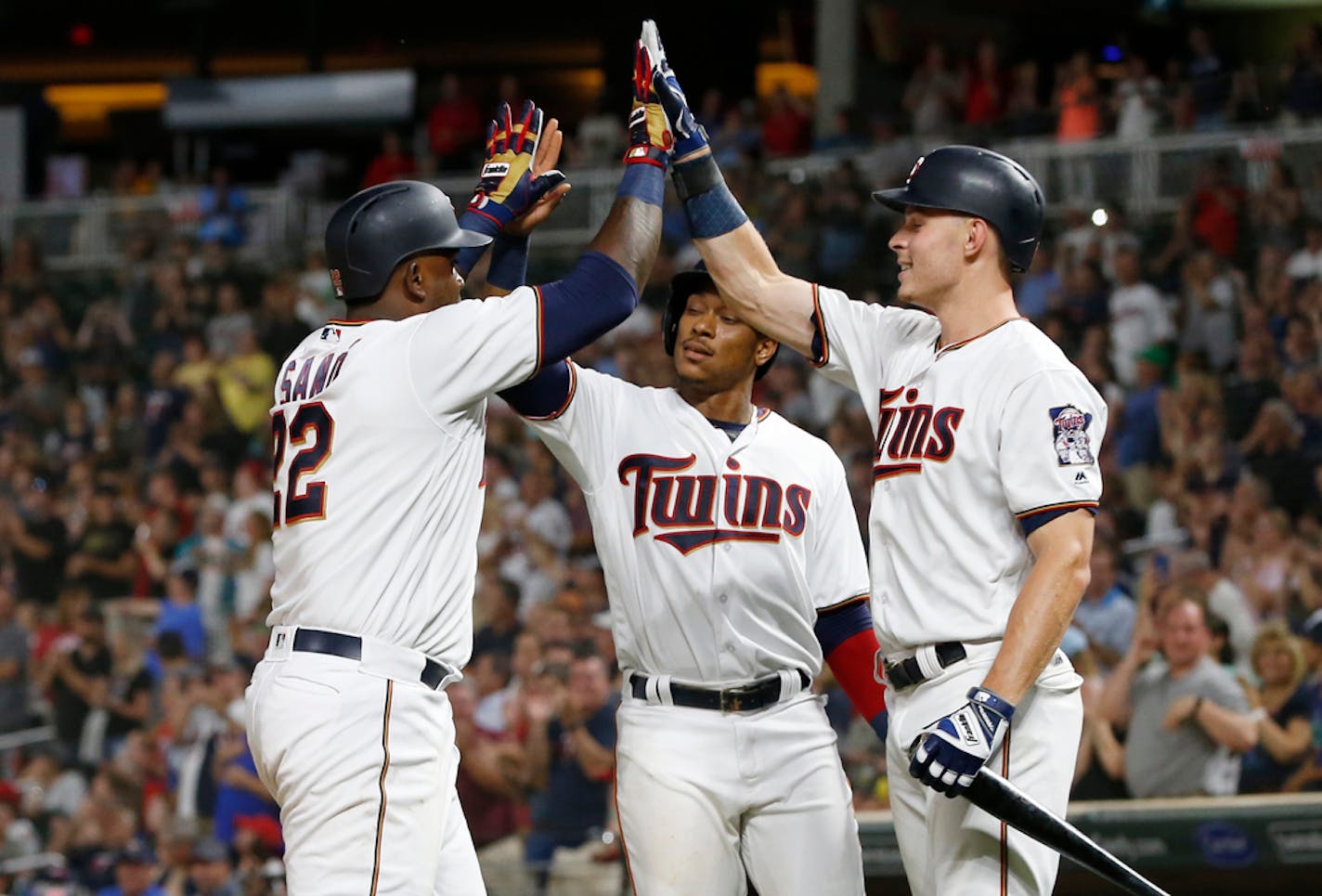 Minnesota Twins' Miguel Sano, left, celebrates celebrates his two-run home run off Pittsburgh Pirates pitcher Richard Rodriguez with Jorge Polanco, center, and Max Kepler in the eighth inning of a baseball game Tuesday, Aug. 14, 2018, in Minneapolis. The Twins won 5-2. (AP Photo/Jim Mone) ORG XMIT: MNJM114